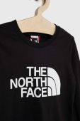 Дитячий бавовняний лонгслів The North Face колір чорний з принтом