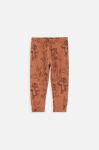 Дитячі спортивні штани Coccodrillo x Loonet Tunes колір коричневий візерунок