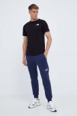 Бавовняні спортивні штани The North Face колір синій однотонні