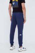 Бавовняні спортивні штани The North Face колір синій однотонні