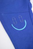 Дитячі спортивні штани Coccodrillo колір синій з принтом
